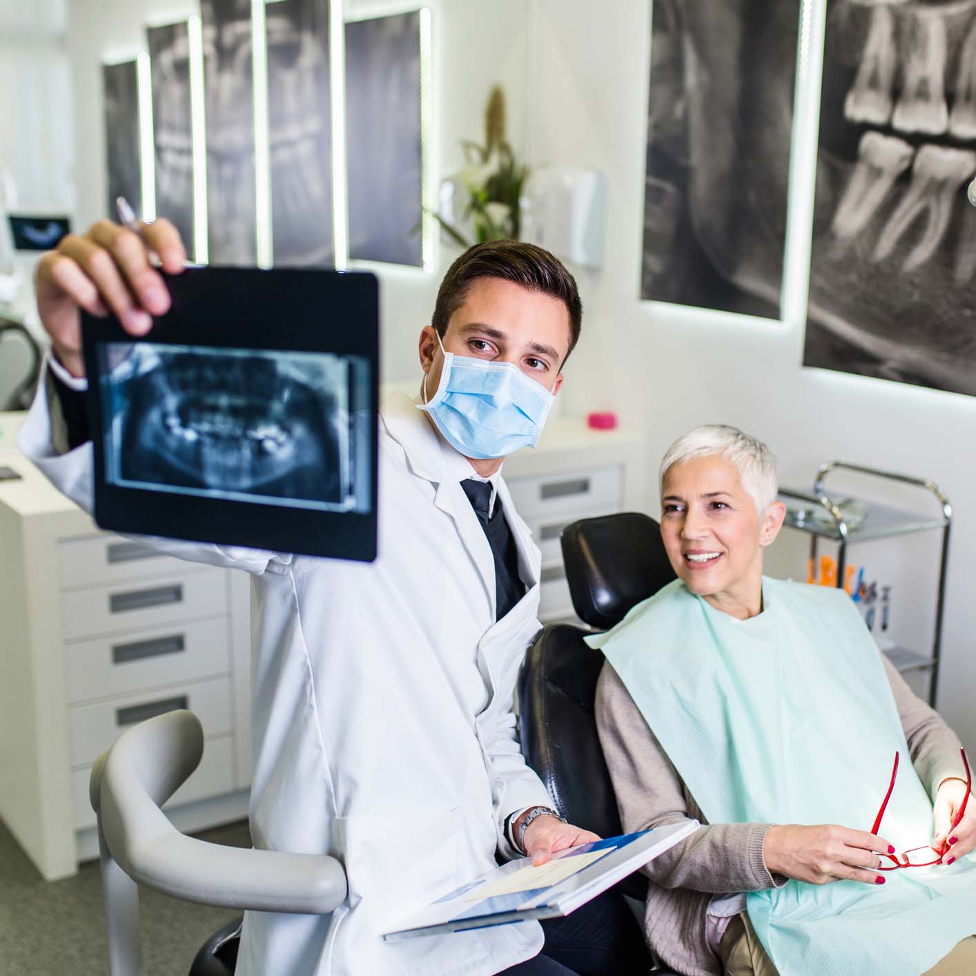 dentist and patient looking at xray